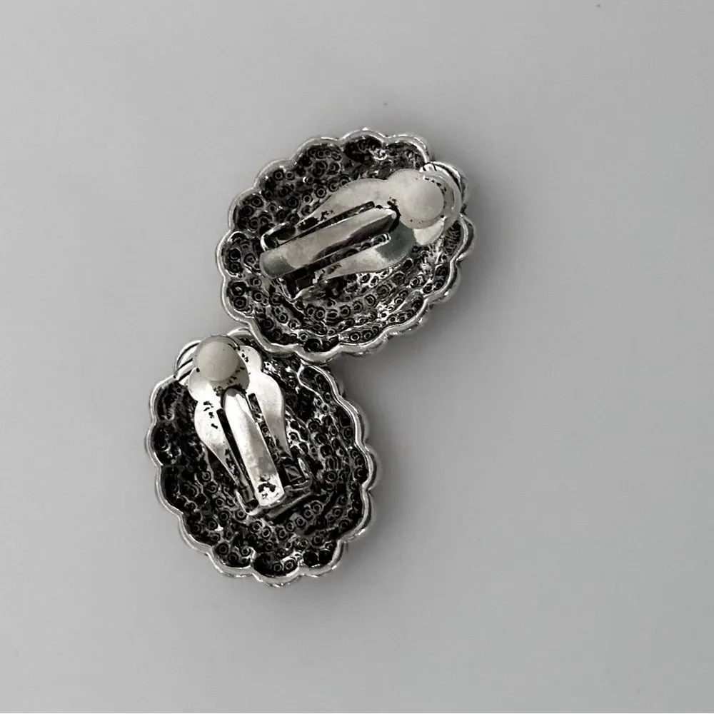 Vintage Sterling Silver Oval Clip-On Earrings with a black stone.